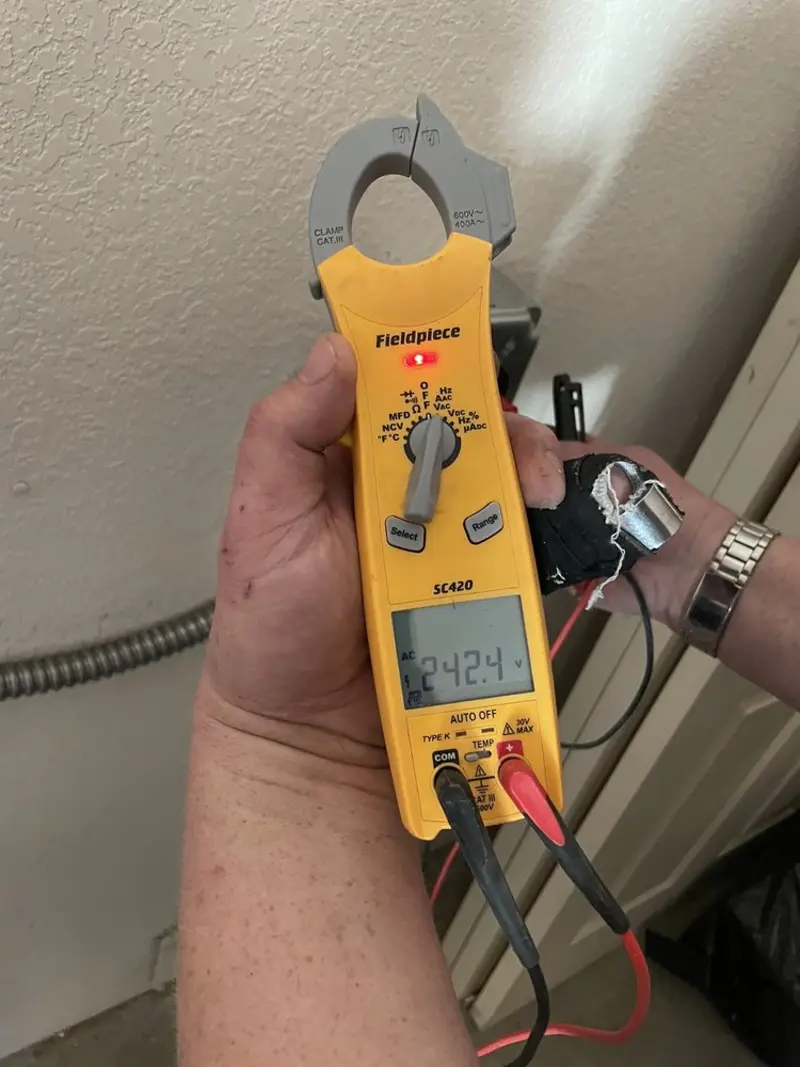 Voltage testing with clamp meter during Ceiling Fan Installation in Kerrville